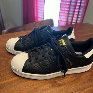 Black leather adidas original women’s superstars